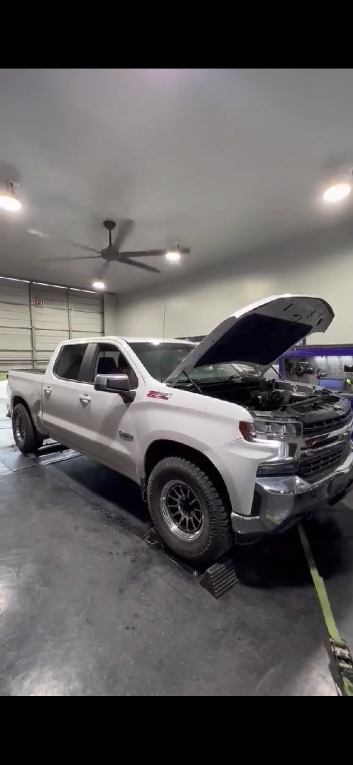 White Chevrolet truck in a repair bay